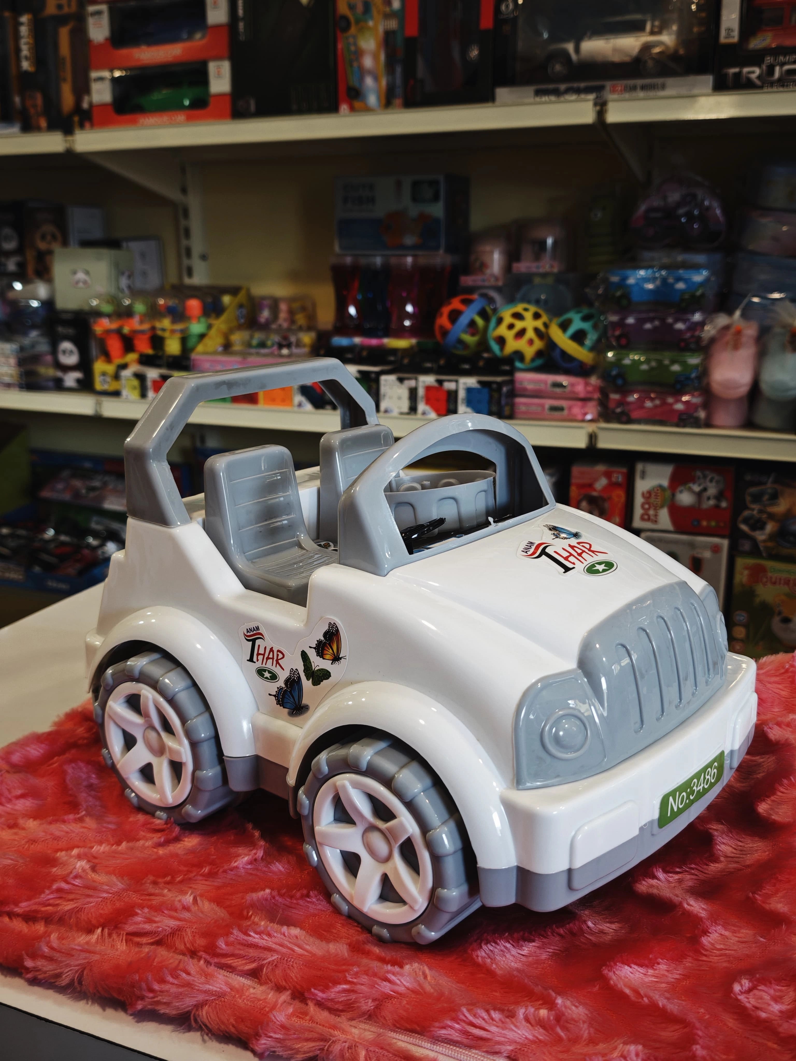 A friction powered toy jeep